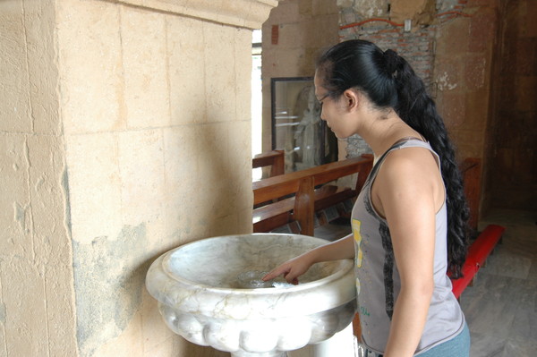 미아가오 성당안에서 성수로 성호를 긋는 필리핀 여성 @뉴스코리아 이학철 특파원