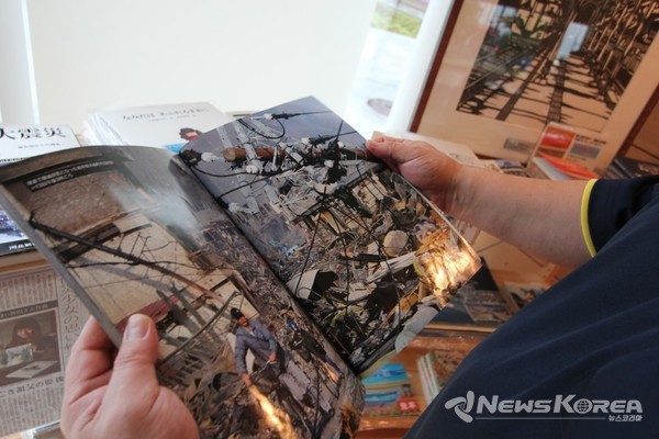 2011년 3월 쓰나미의 흔적들을 담은 사진집을 보고 있다. @뉴스코리아 김양현 특파원