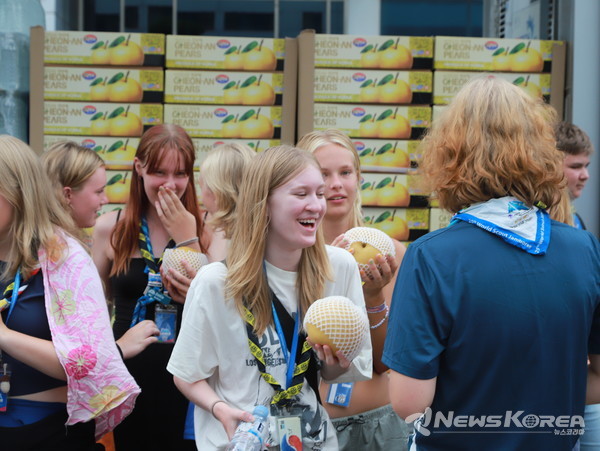 잼버리 단원들이 성환읍 주민자치회에서 준비한 성환의 명물 배를 받아 들고 웃음 짓고 있다.  @천안시