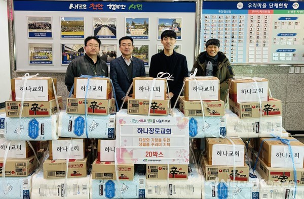 천안하나장로교회 관계자들이 24일 생필품 꾸러미를 기탁하고 정원진 신방동장과 함께 기념사진을 촬영하고 있다. @천안시