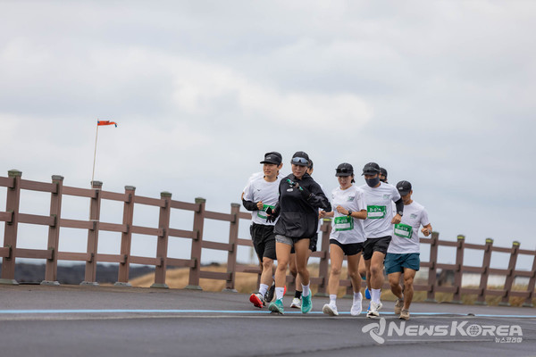 [제주 바다를 배경으로 달리는 러너들] 서귀포 해안선을 따라 바다를 옆에 두고 힘차게 달리는 참가자들. @제주관광공사