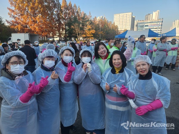 김행금 천안시의회 의장이 함께 김장 봉사에 참가한 봉사자들과 기념사진을 찍고 있다. @뉴스코리아 최신 기자