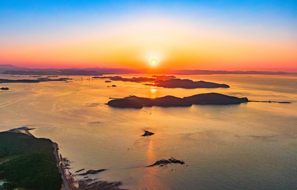 보령 앞바다에 펼쳐진 일몰 풍경. 여러 섬 사이로 햇빛이 드리워지며 섬비엔날레의 공간적 배경을 상징한다.@충청남도